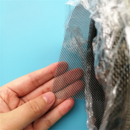 A hand is holding a corner part of the super duplex wire mesh roll.